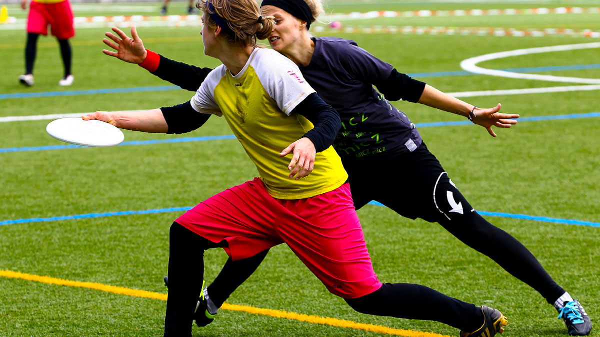 Two genders playing ultimate frisbee together